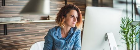 woman looking at her computer